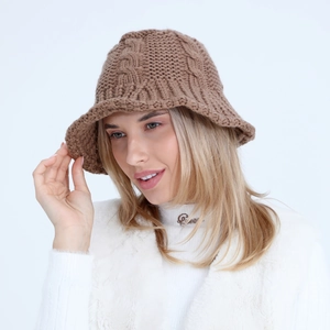 Detailed close-up of brown cable knit bucket hat with textured thick braid pattern