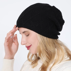 Detail of black knit beanie with diamond lattice pattern and soft fleece lining