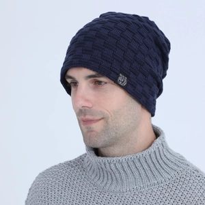 Detailed knit texture of dark blue beanie featuring a bear logo side patch