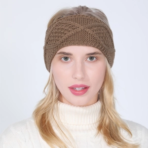 Close-up of brown cable knit headband with criss-cross pattern worn by a model