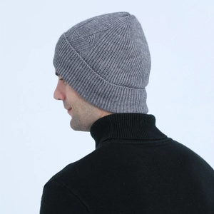 Detail of grey cable knit winter beanie with thick ribbed cuff and warm textured pattern