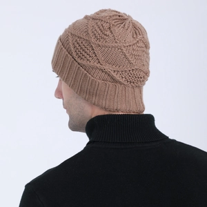 Close-up of khaki brown knitted beanie with diamond pattern and ribbed edge detail