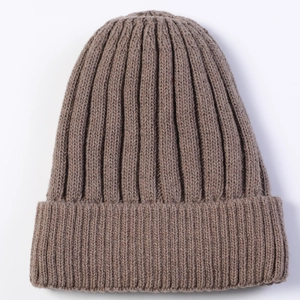 Macro detail of the thick ribbed knit texture on a dark brown winter beanie hat