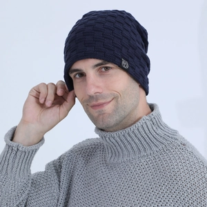Detail view of navy blue knitted beanie with 3D waffle texture and side logo patch