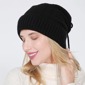 Close-up of black ribbed knit beanie with rolled edge and thick texture for winter