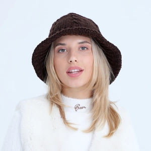 Detail of dark brown cable knit fisherman hat showing thick textured crochet weave