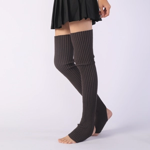 Detail of dark grey knitted over-knee leg warmers with ribbed texture and stirrup design