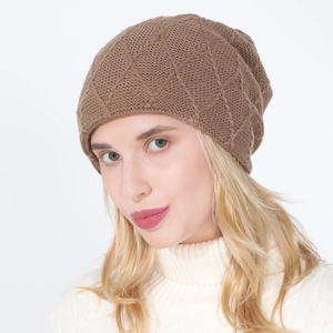 Detailed view of brown knit beanie featuring a diamond lattice pattern and soft texture