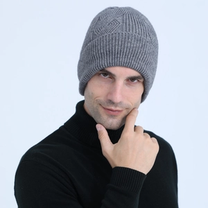 Close-up of grey cable knit beanie showing thick texture and diamond pattern weave
