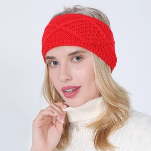 Close-up of bright red cable knit headband showing thick wool texture and diamond pattern