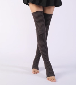Close-up of brown knit leg warmers showing vertical ribbed texture and over-the-knee length
