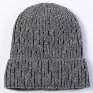 Detailed view of dark grey cable knit pattern and ribbed cuff on warm men's winter beanie