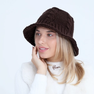 Close-up of dark brown knit bucket hat featuring classic twist texture and warm wool yarn