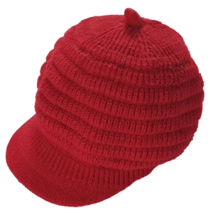 Close-up of bright red knitted beret with visor and cozy ribbed wool texture