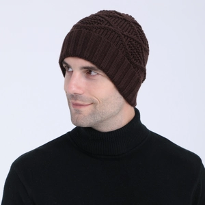 Close-up of knit winter beanie featuring diamond jacquard pattern and ribbed cuff detail