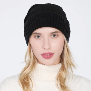 Close-up of black ribbed knit beanie showing soft texture and elastic winter fit