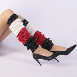 Detailed knit texture of tricolor snowflake patterned leg warmers with boots