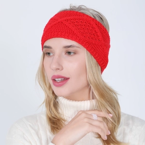 Detail of red cable-knitted headband with diamond pattern and soft wool texture