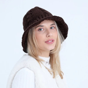 Detailed texture of dark brown knit bucket hat made of warm chunky woolen yarn material