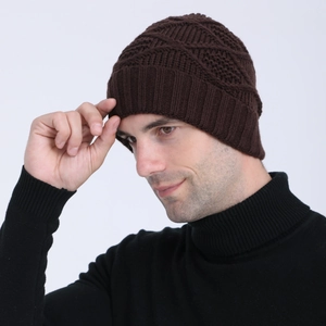 Detailed side view of dark brown knitted beanie with diamond pattern and ribbed cuff