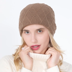 Close-up of knit beanie showing diamond lattice pattern and warm fleece lining
