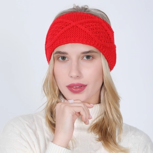 Detail of red cable knit headband showing thick cross-knot texture for winter