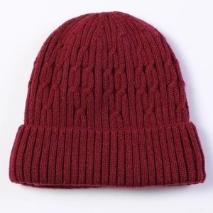 Detailed cable knit pattern on burgundy men's winter hat with ribbed folded cuff
