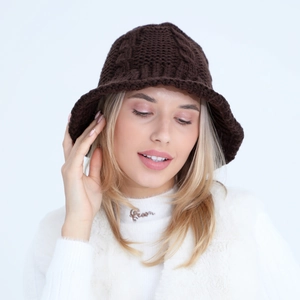 Detailed view of dark brown twist knit pattern on a warm winter bucket hat for women