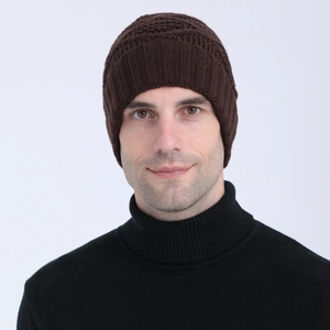 Detail view of thick dark brown knit beanie with elastic ribbed cuff for winter warmth