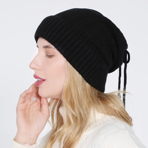 Detail view of the black knit beanie showing rib-knit texture and rear adjustable drawstring