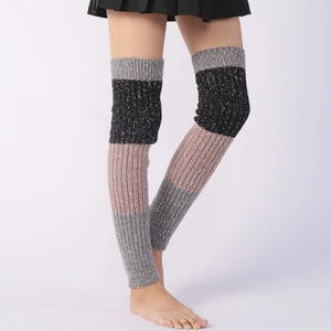 Detail of multi-color knitted leg warmers showing ribbed texture and chunky wool material