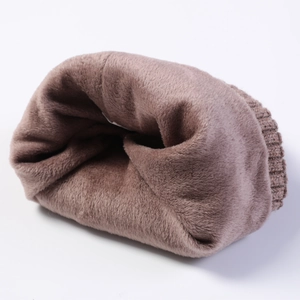 Detail of thick fleece lining and dense knit texture on a dark brown winter beanie