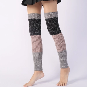 Detailed knit texture of over-the-knee color-block leg warmers with ribbed cuffs