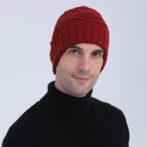 Close-up of deep red knitted beanie with thick texture and wide fold for winter warmth