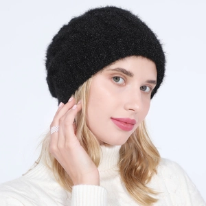Detail of black knitted beret with shimmering metallic yarn and soft plush texture