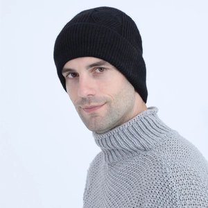 Detail of black knitted beanie with vertical textures and fleece lining for winter warmth