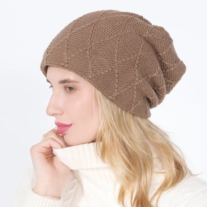 Detailed side view of brown knit slouchy beanie with 3D diamond grid pattern