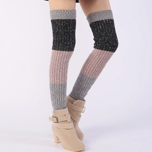 Detailed knit texture of multi-colored striped over-knee leg warmers with boots