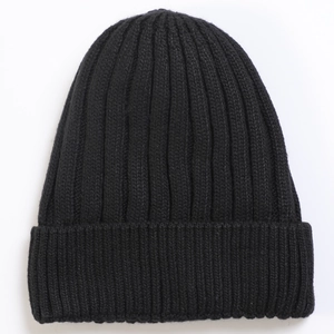 Close-up of black ribbed knit beanie showing vertical elastic texture and wide cuff