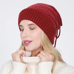 Close-up of dark red knitted beanie featuring ribbed texture and warm fleece lining