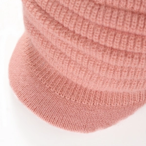 Detail of pink knitted beanie showing vertical rib pattern and thick warm texture
