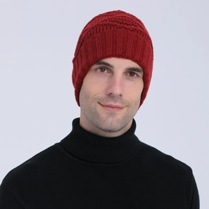 Close-up of deep red ribbed knit beanie showing thick warm texture and snug fit on model