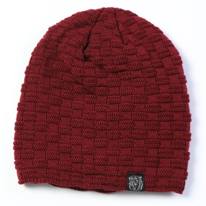 Detailed view of burgundy knit beanie with waffle texture and a bear logo patch
