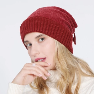 Detail of the deep red knitted beanie showing the vertical ribbed texture and warm fabric