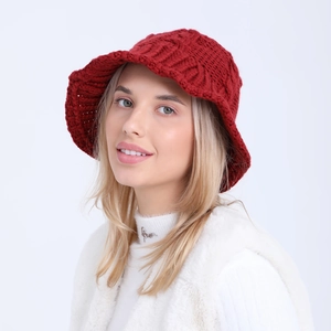 Detail of burgundy chunky knit bucket hat showing hollow crochet and cable stitch texture