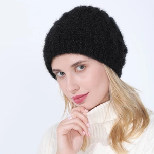 Close-up of black knitted beanie with soft plush texture worn by blonde model
