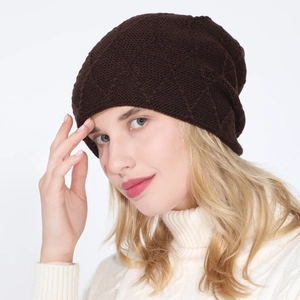 Detail of dark brown knit beanie featuring a delicate diamond lattice pattern and soft lining