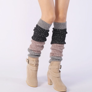 Detail of ribbed knit leg warmers in color-block grey and pink with suede ankle boots