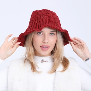 Detailed close-up of dark red twisted knit bucket hat with wave edge texture