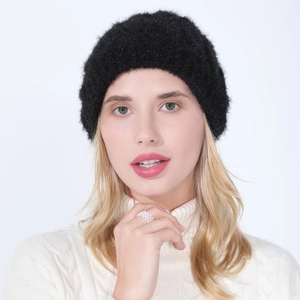 Close-up of black knit beret featuring soft mohair texture and subtle silver glitter finish